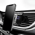 Glory black car phone holder clipped onto a car air vent, holding a mobile phone.