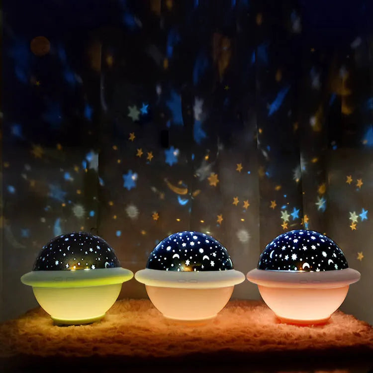Pink UFO-shaped plastic LED night light projecting starry sky pattern on wall