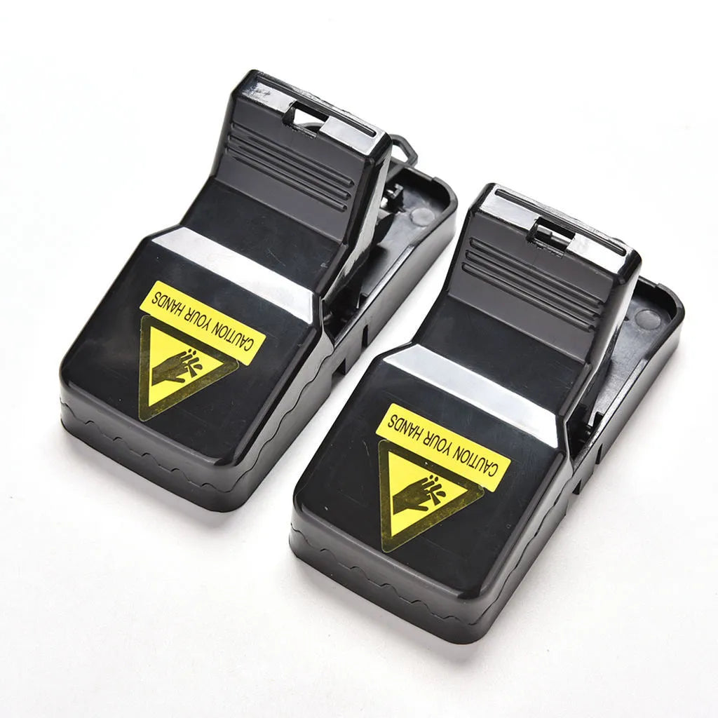 Six black plastic snapping mousetraps with dimensions 11cm long by 5cm wide