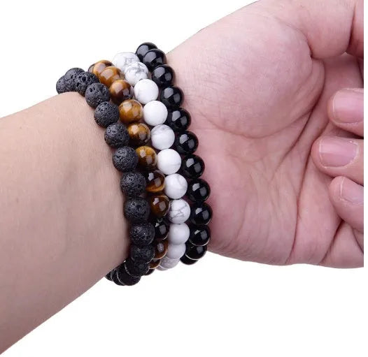 Geometric black onyx stretch bracelet with 8mm agate beads on an elastic cord.