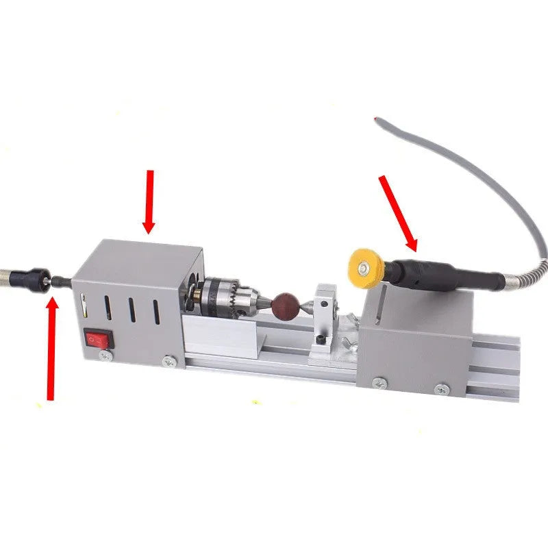 Mini metal woodworking lathe with carving knives and accessories on workbench