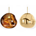 A modern irregular shaped glass chandelier with a Nordic design in a gold finish, hanging from a ceiling.