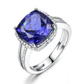 Close-up of a women's sterling silver ring with a blue tanzanite gemstone.
