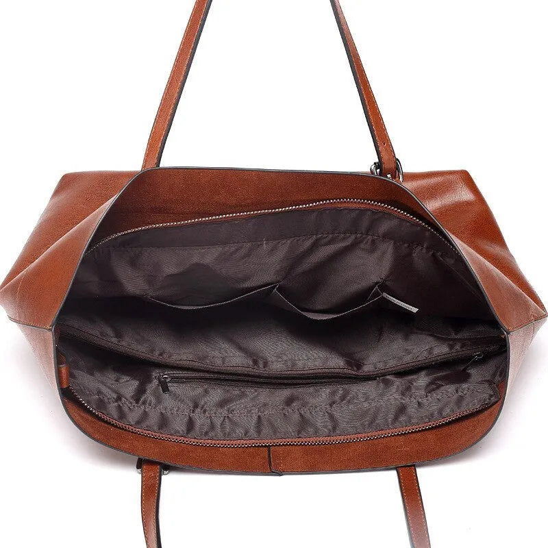 Brown waxed cowhide cross-body handbag showing front flap and adjustable shoulder strap.