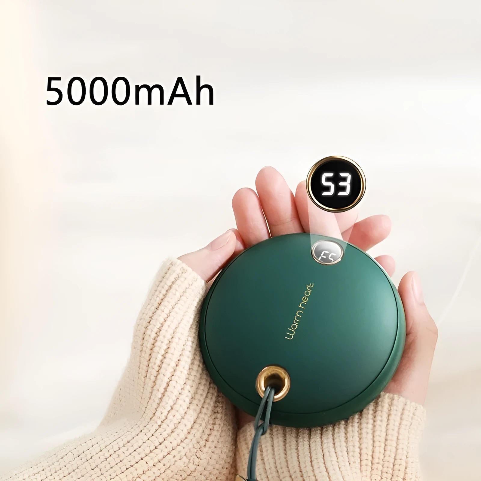Green square hand warmer power bank with digital display showing charge level, next to a charging cable.
