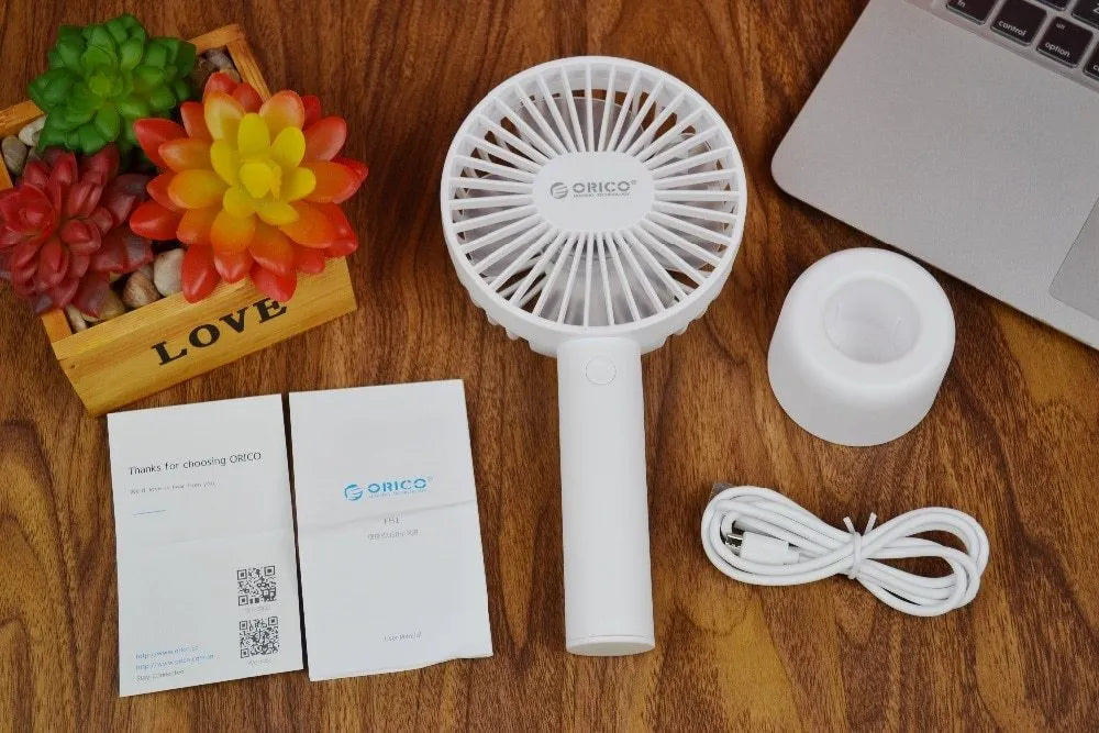 White ORICO FH1 portable USB rechargeable desk fan with three-speed buttons and compact handheld design.