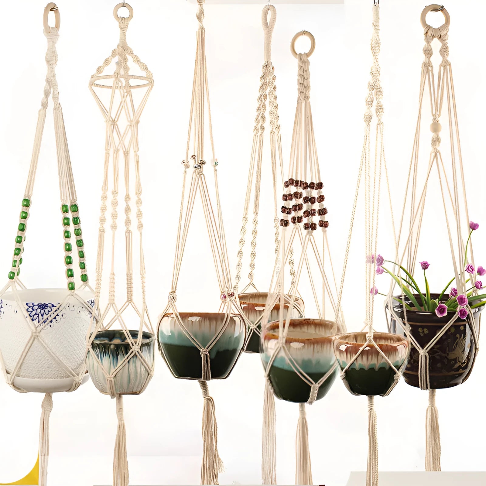 A rustic-style woven cotton rope plant trellis panel supporting green leaves.