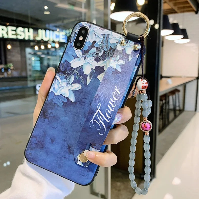 Samsung Galaxy phone case with folding bracket extended, showing floral pattern design