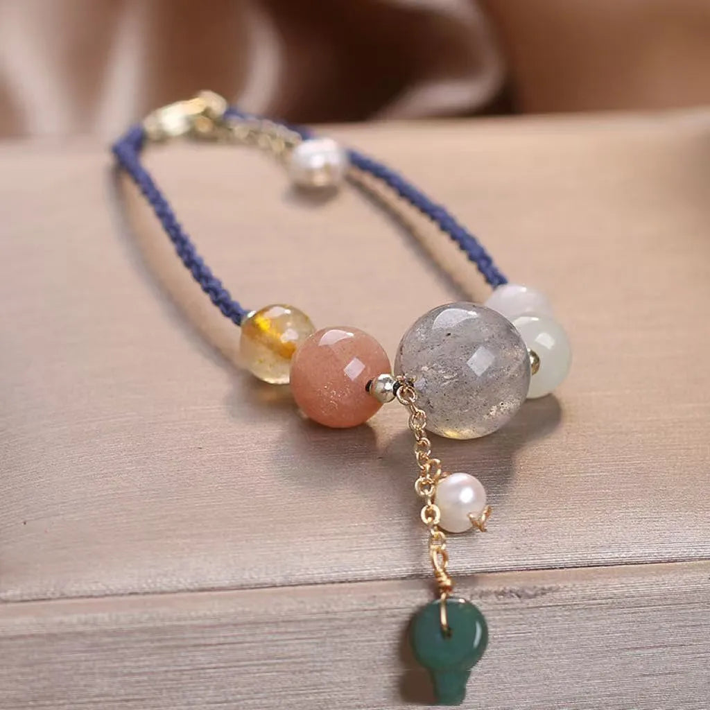 Hand-woven women's crystal bracelet with peace buckle clasp and sequin accents