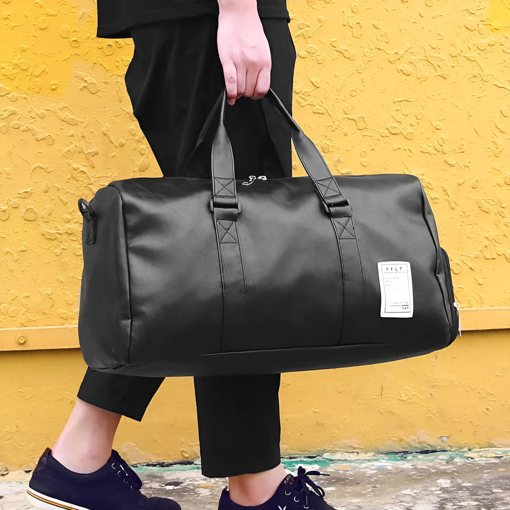 Black waterproof sports duffle bag with a separate side shoe compartment and diagonal shoulder straps.
