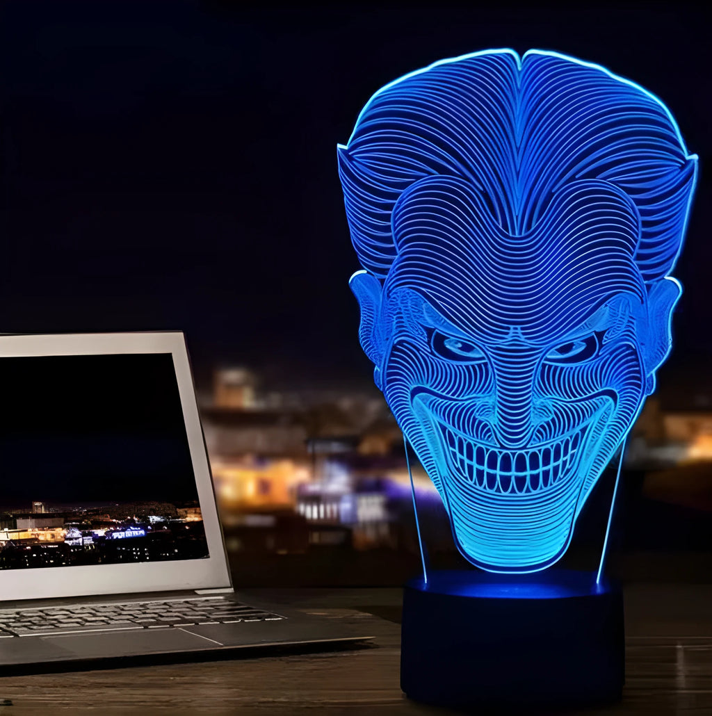 USB-powered 3D acrylic LED lamp displaying multiple colours on a desk with remote control.