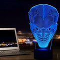 USB-powered 3D acrylic LED lamp displaying multiple colours on a desk with remote control.