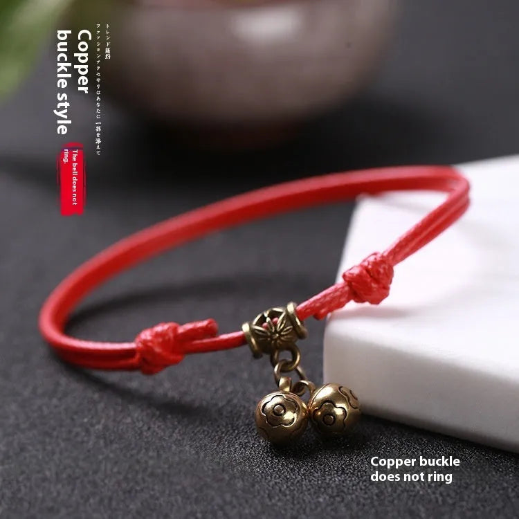 A nylon rope dog collar with a brass buckle shown alongside a version with a brass bell, in black, red, and coffee colours.