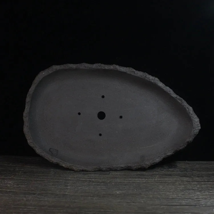 Handmade purple clay flower pot showing natural ceramic texture and floor-standing design
