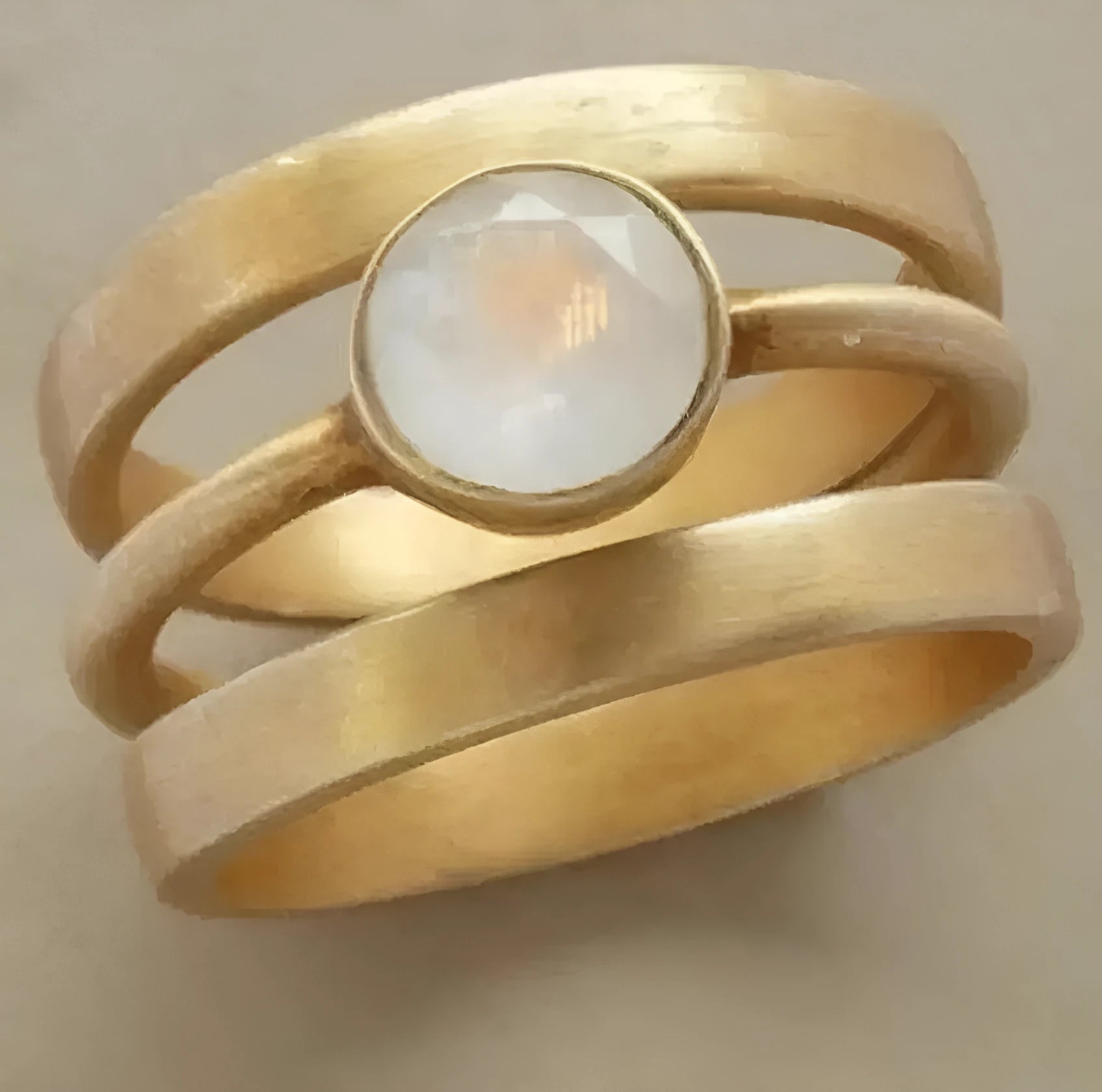 Gold-plated geometric titanium steel ring with a micro-inlaid white chalcedony stone.