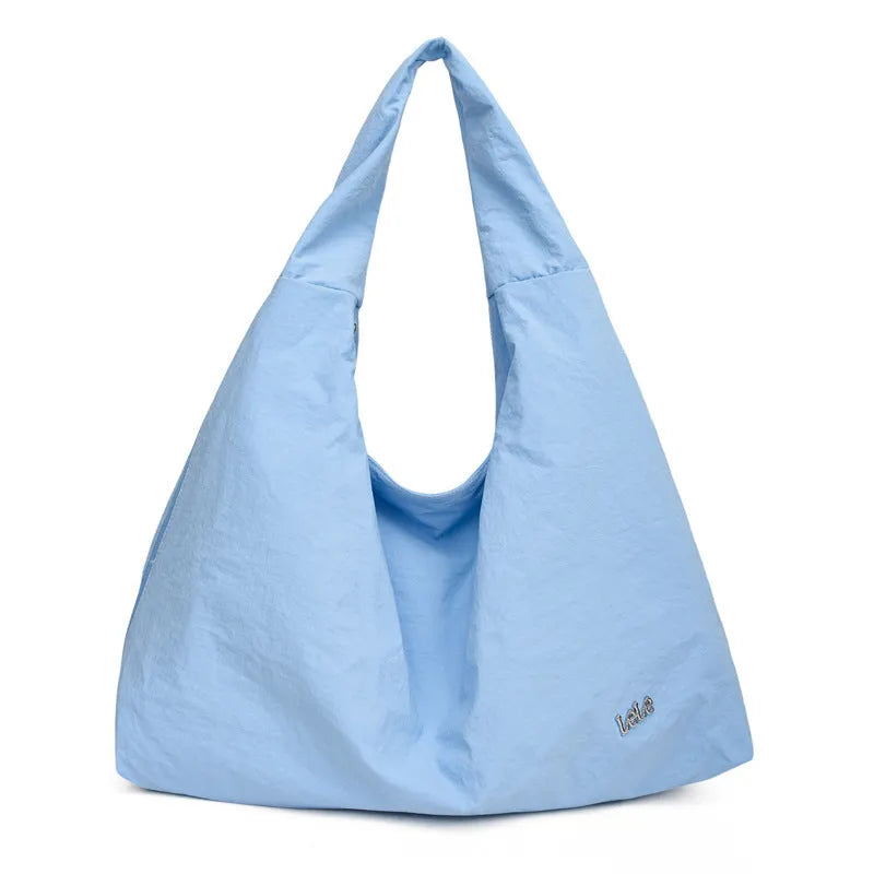 Soft heart-shaped nylon underarm bag for women shown in black, blue, khaki, and yellow.