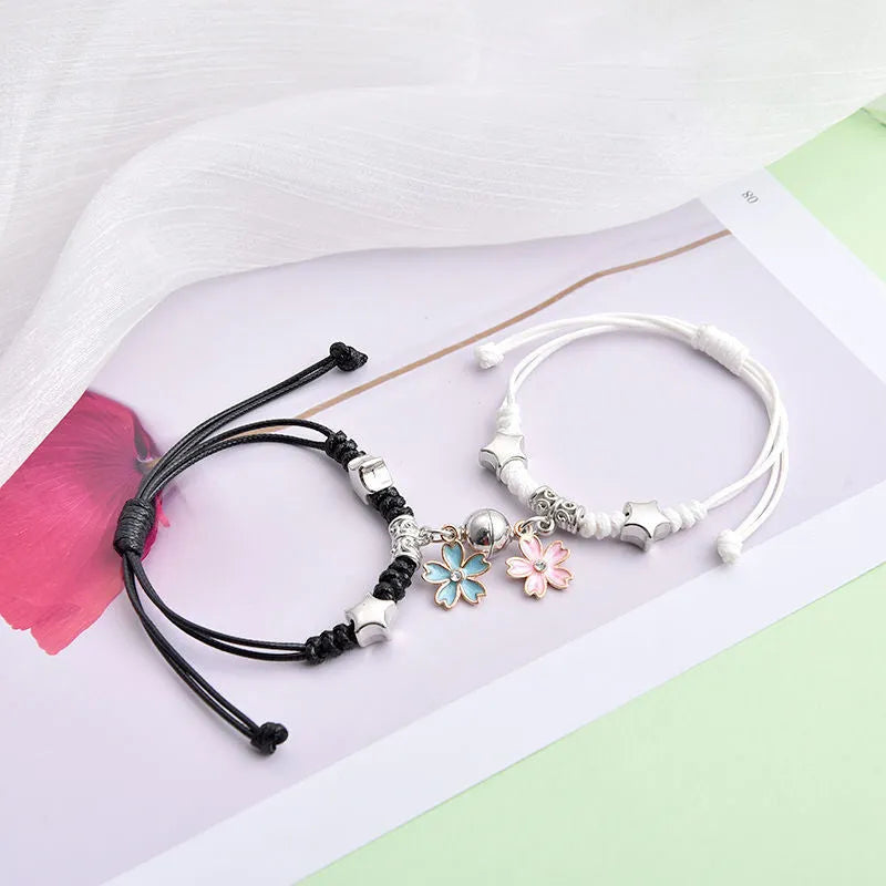 Magnet suction couple bracelets with alloy construction and various pendant designs including crowns and hearts