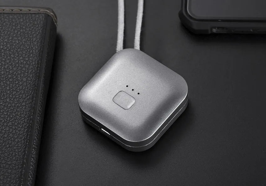 Pink portable USB air purifier necklace with charging cable showing compact wearable design