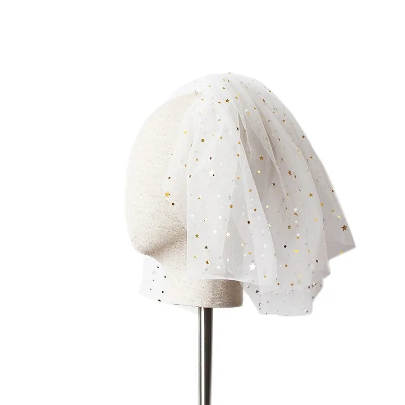 White yarn bridal multi-layer short veil with hair comb on a neutral background