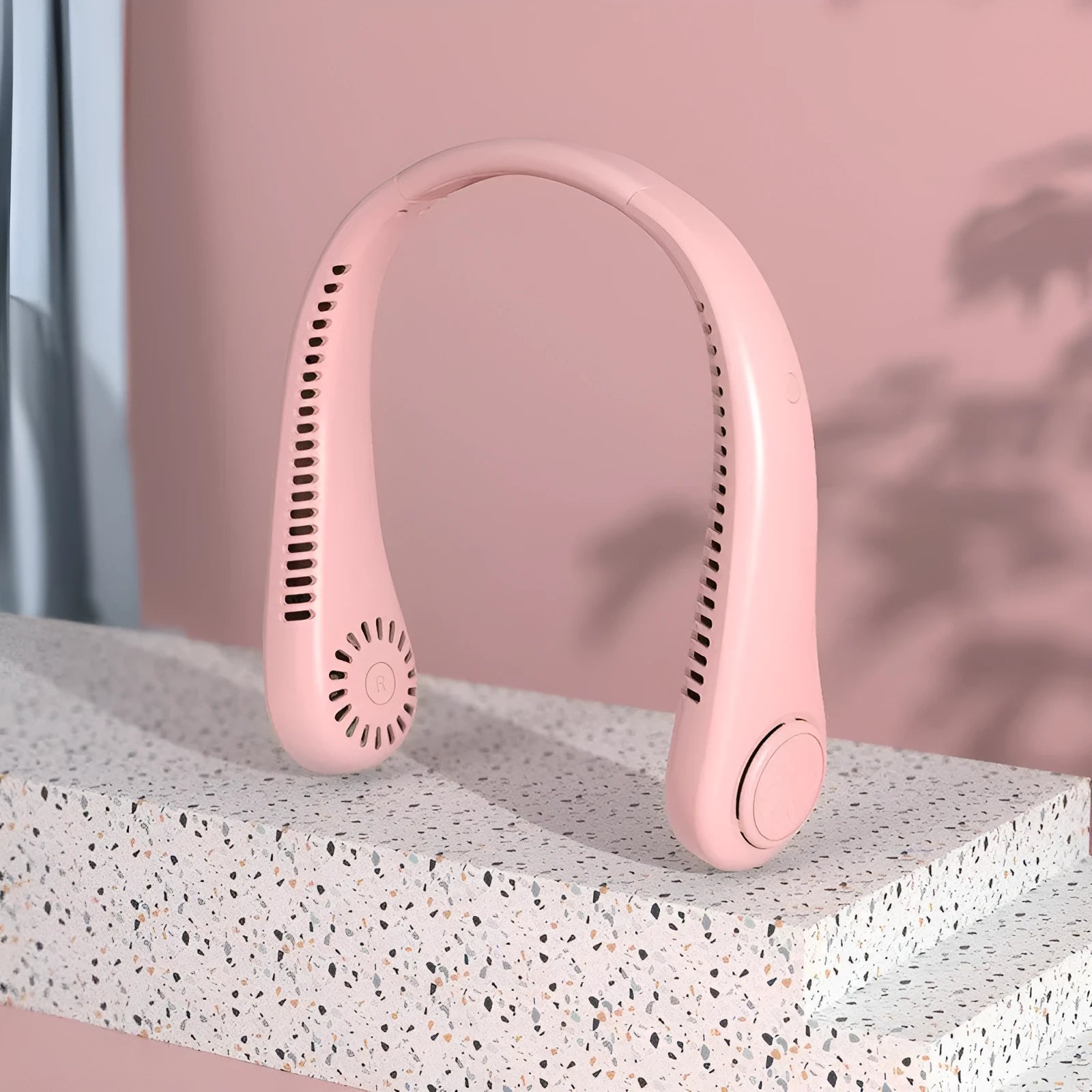 Pink USB rechargeable bladeless neck fan worn around the neck.