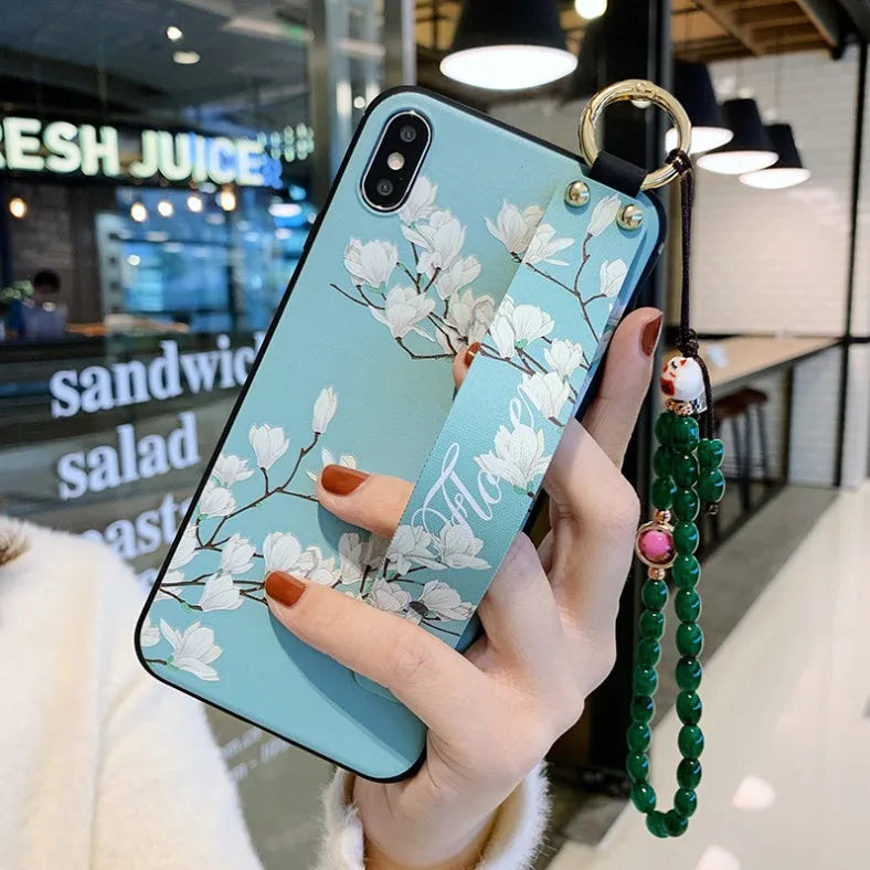 Samsung Galaxy phone case with folding bracket extended, showing floral pattern design