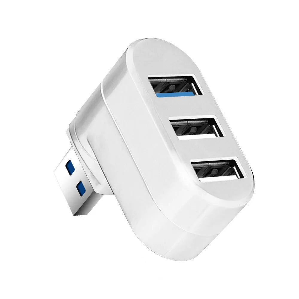 Black USB 3.0 four-port rotary hub on a desk next to a laptop, showing its compact size and rotating design.