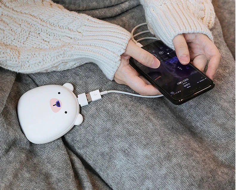 Cartoon penguin polar bear USB rechargeable hand warmer and power bank unit.