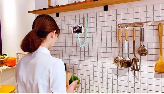 Black flexible rubber phone holder with suction cup extended to 62cm length on a desktop