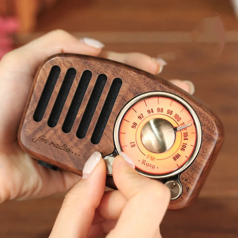 Retro wooden mini Bluetooth speaker in walnut finish showing front grille and side USB port