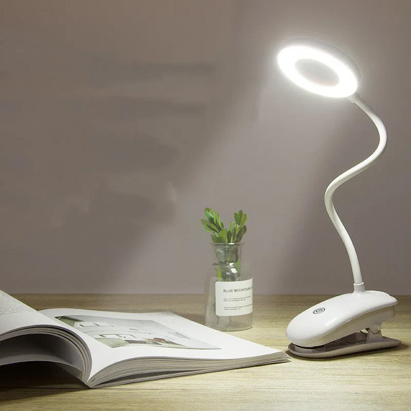 White rechargeable clip-on desk lamp with a modern plastic shade and touch switch