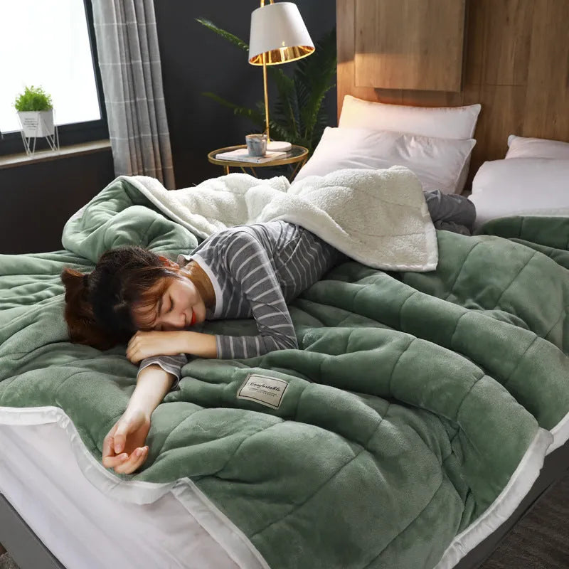Thick coral fleece winter blanket in a solid colour, shown on a bed, dimensions 150cm by 200cm.