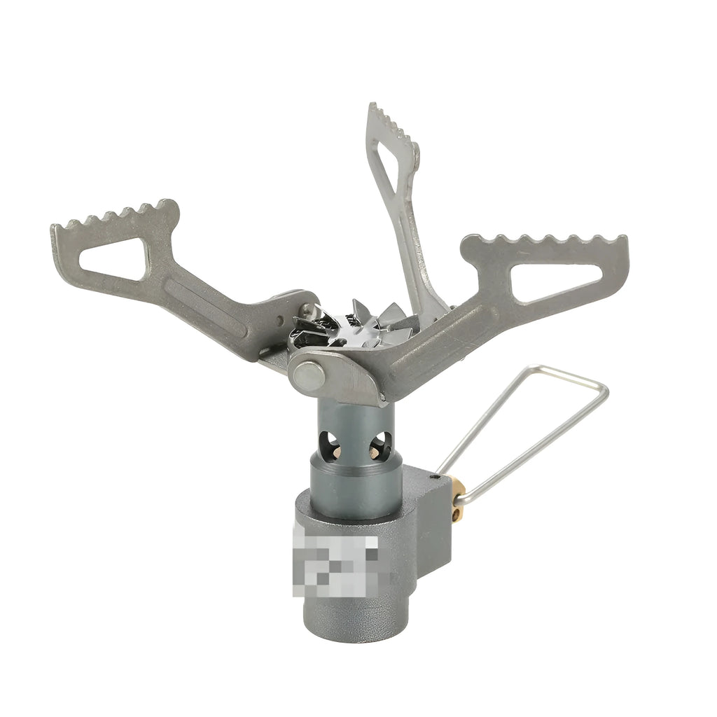 Compact one-piece propane camping stove on rocky ground, fuel canister attached, with a pot boiling.