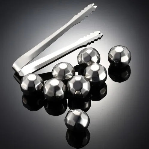 Set of eight stainless steel whiskey chilling stones and metal clip in storage box.