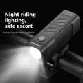 A black USB rechargeable bicycle headlight mounted on handlebars with a quick-release strap.