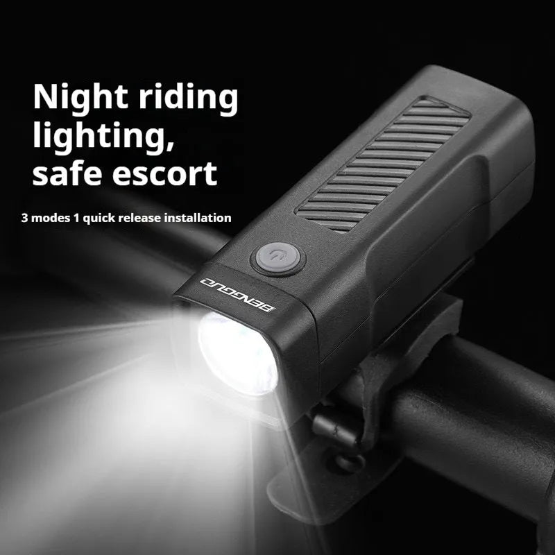 A black USB rechargeable bicycle headlight mounted on handlebars with a quick-release strap.