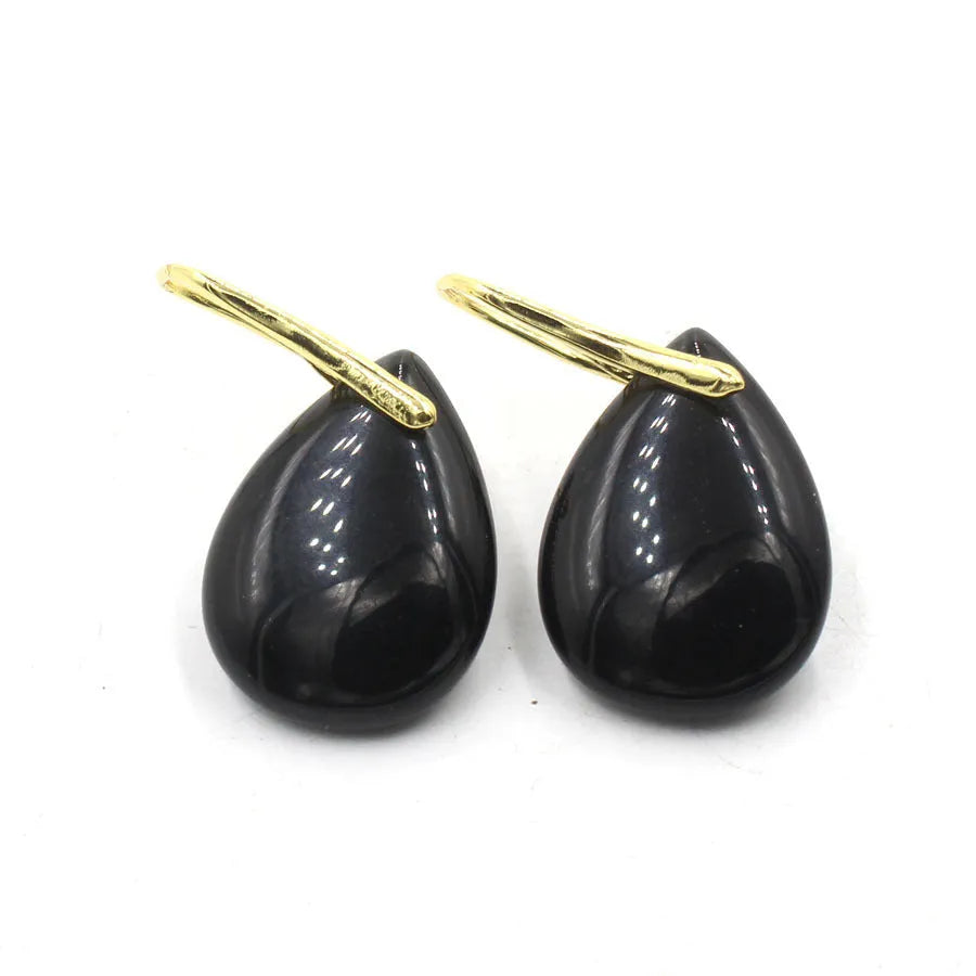 A pair of geometric water drop shaped earrings made from crystal in an electroplated finish.