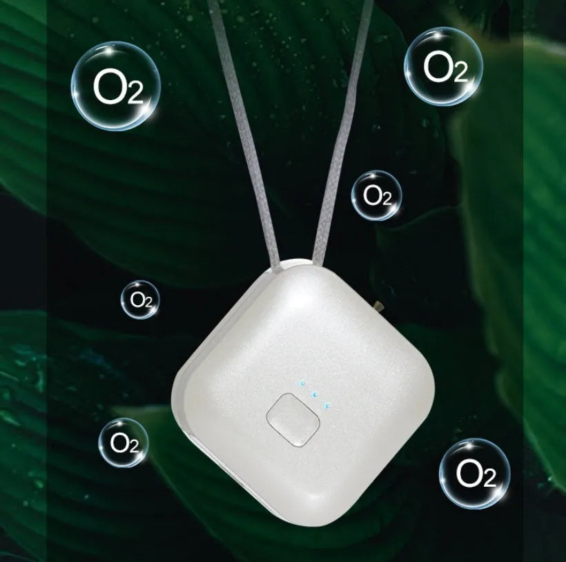 Pink portable USB air purifier necklace with charging cable showing compact wearable design