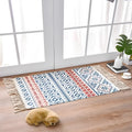 Handwoven cotton linen floor mat 60x90cm in ethnic style with natural plant dye, placed on a wooden floor
