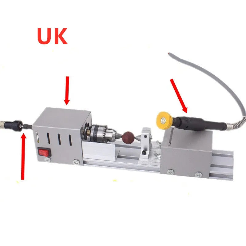 Mini metal woodworking lathe with carving knives and accessories on workbench