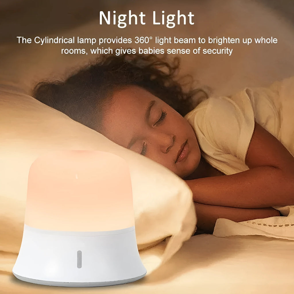White cylindrical touch control bedside night light with USB charging cable.