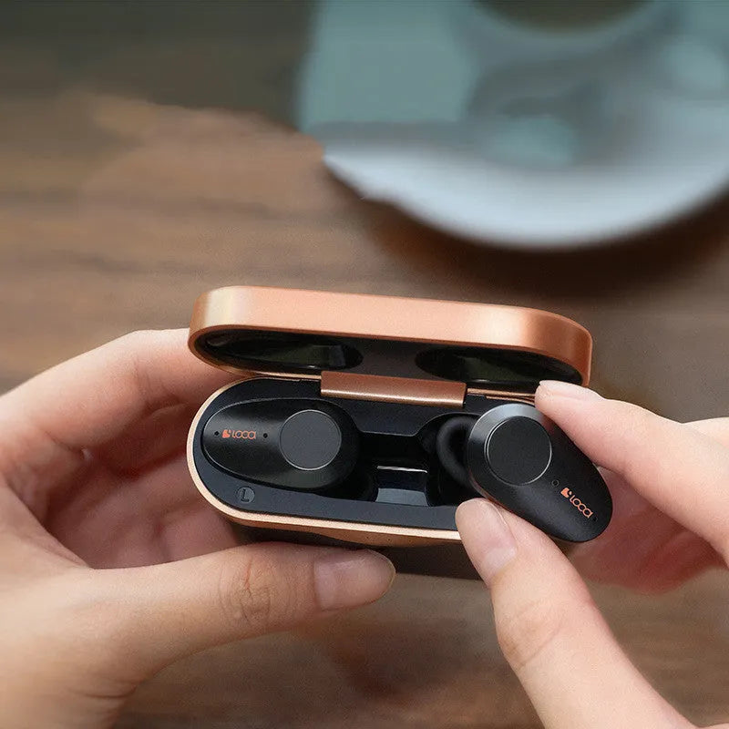 Black wireless Bluetooth headset with charging stand showing bilateral earbuds and Type-C charging port
