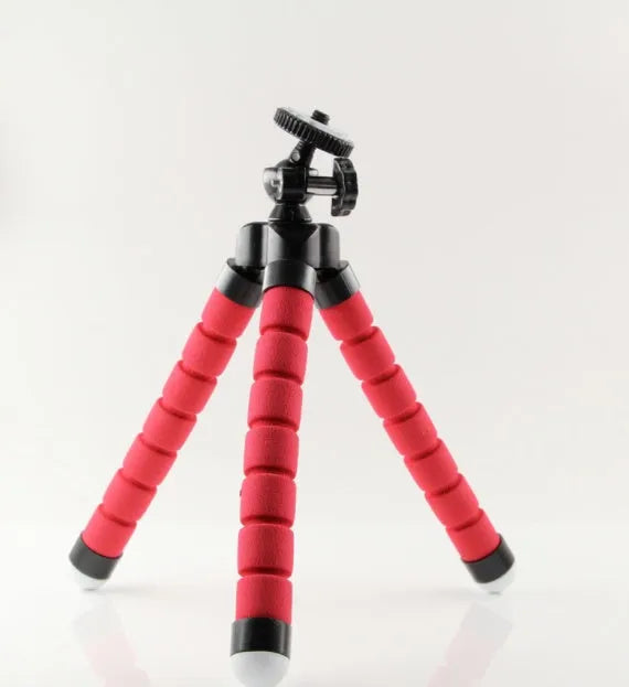 Black flexible octopus tripod with bent legs wrapped around a pole, showing a smartphone attached.