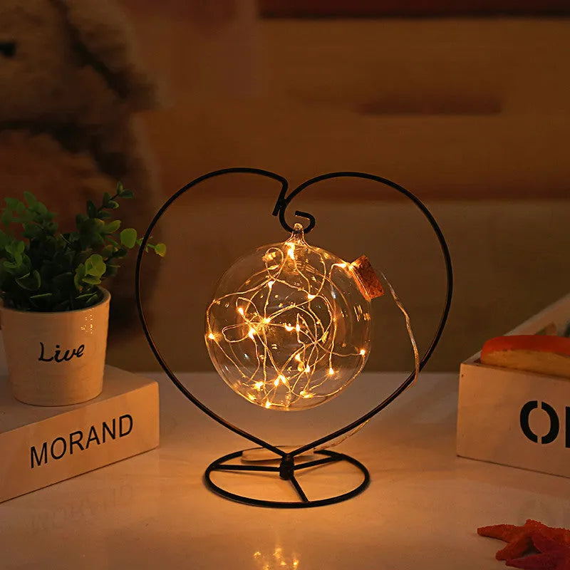 Round glass wish bottle with cork, 12 cm diameter, containing a warm white LED light strand with 20 lamp beads and folded paper stars