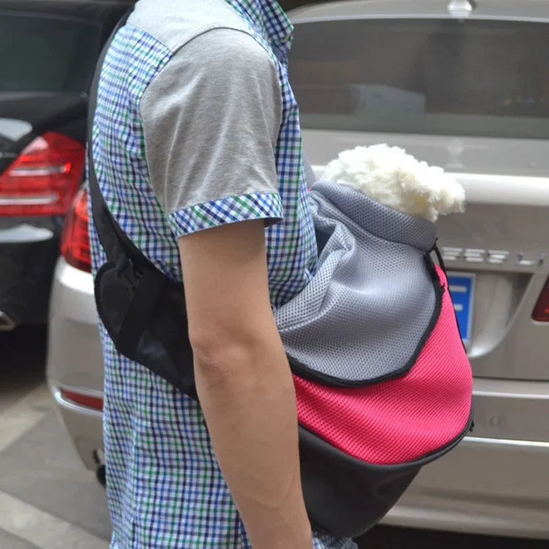 Blue pet carrier backpack for a small dog, showing padded interior and shoulder straps.