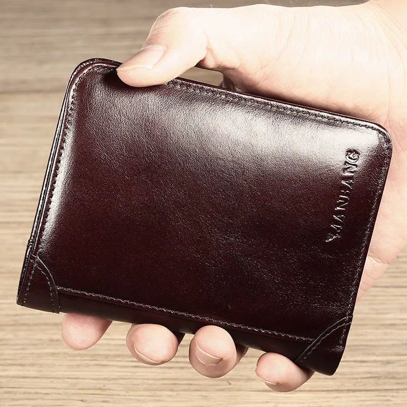 Men's black full-grain leather bifold wallet open, showing card slots, zip coin pocket, and banknote section.