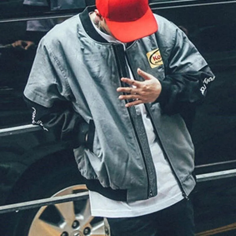 Hip hop style printed baseball jacket in Grey with round neck and side slit pockets on a model