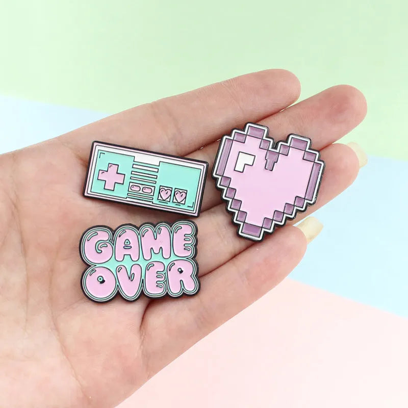 Solid alloy metal game console badge pin on a clear OPP packaging background.