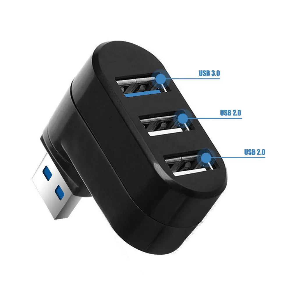 Black USB 3.0 four-port rotary hub on a desk next to a laptop, showing its compact size and rotating design.