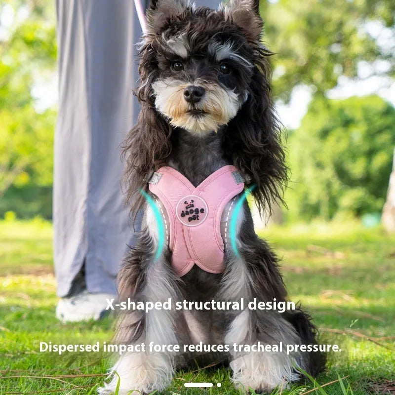 Pink polyester dog vest with an attached hand holding rope laid flat