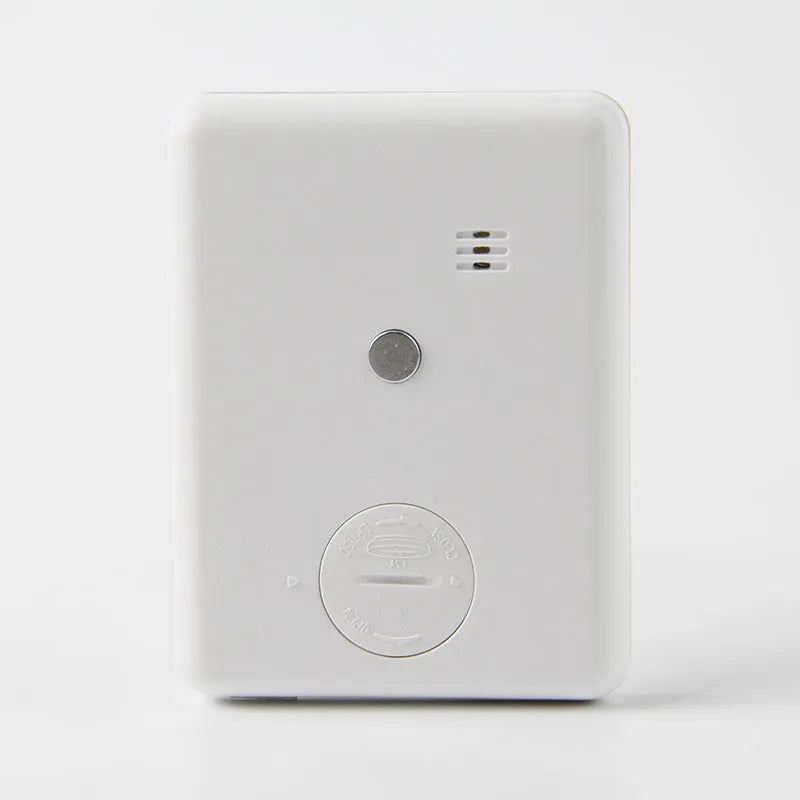 Black or white plastic digital kitchen timer with LCD display and magnetic back.